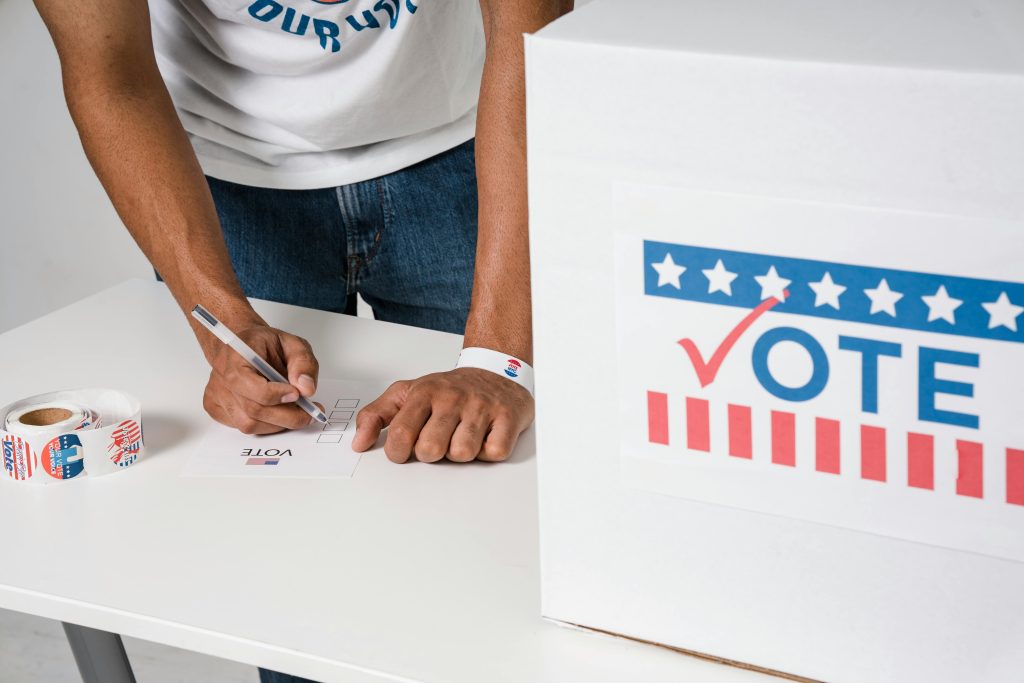 Close-up of man voting at ballot box, emphasizing democratic participation.